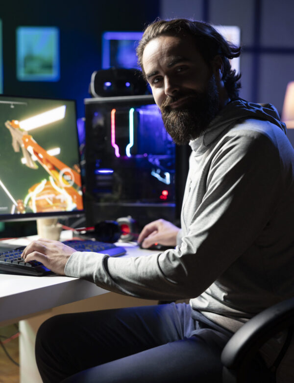 Home close up of cheerful gamer streaming game in neon lit studio